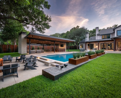 Backyard pool with gravel rock firepit and seating area in Dallas, Texas